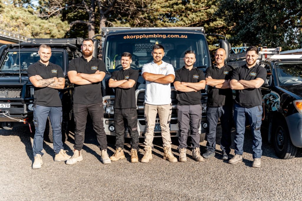 EKORP Plumbing team standing in front of service vehicles providing residential and commercial plumbing services across Sydney NSW